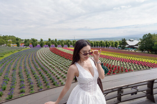 ​Woman with colorful flower fields background.