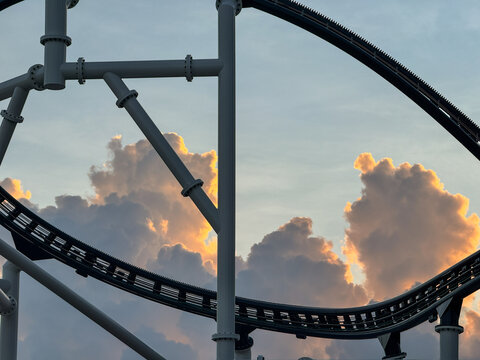 Attraction roller-coaster with the background of the cloudy sky