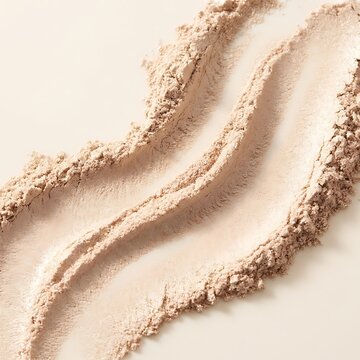 Three smooth waves of soft beige face powder makeup cosmetic product texture on a plain flat surface. poudres