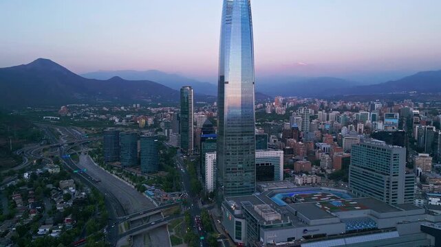 Aerial view of the Gran Torre Santiago skyscraper rising above the city skyline with the Andes mountains in the background in Santiago, Santiago Metropolitan, Chile.