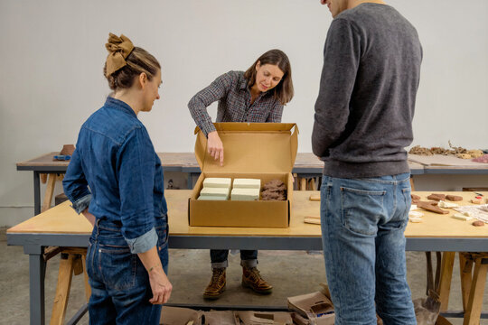 Craft Workshop Owner Explaining Materials to a Customer