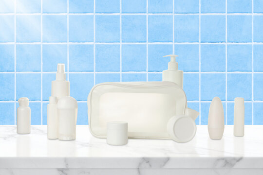 Cosmetics. Cosmetics and a transparent toilet bag are neatly arranged on a marble surface