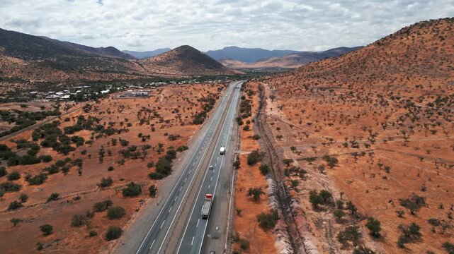 Aerial view of an arid highway stretching through the dry landscape of Region Valparaiso, Chile.