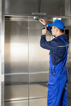 Elevator Technician Calibrating Door Sensor