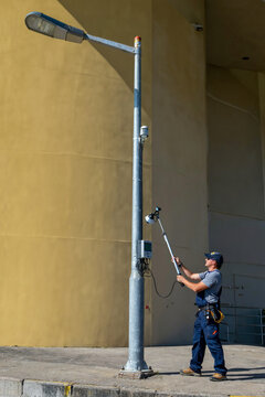 Technician Testing Streetlight Photocell Sensor