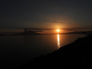 Sunset over Sakurajima with golden reflection on the sea, Kagoshima, Japan © 悠真 橋本