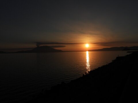 Sunset over Sakurajima with golden reflection on the sea, Kagoshima, Japan