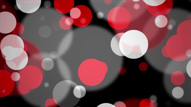 Red and white bokeh circles floating on black background with subtle camera movement