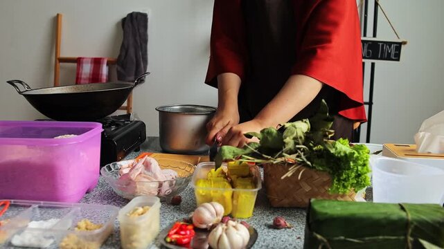 Chef peeling garlic and preparing fresh ingredients for cooking in kitchen