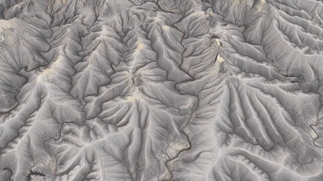 Aerial view of the rugged badlands and eroded clay formations of Factory Butte in Wayne County, Utah, United States.