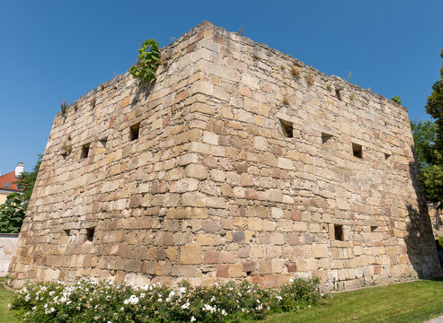 Historic stone defensive structure with gun loops in Eisenstadt, Austria, featuring thick fortified masonry walls and openings designed for shooting from a protected interior space.