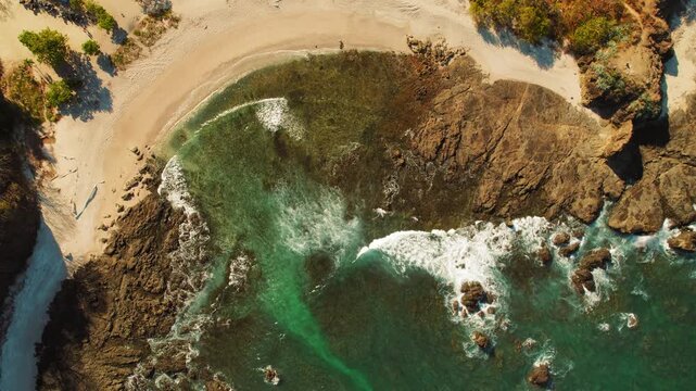 Aerial of San Juanillo beach with turquoise water and rocky shore in Costa Rica
