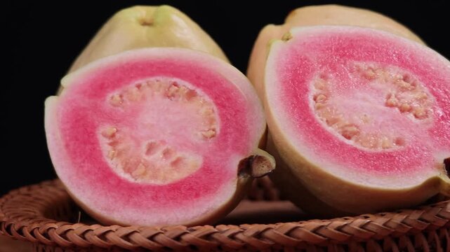 Fresh pink guava fruit with whole and half slice