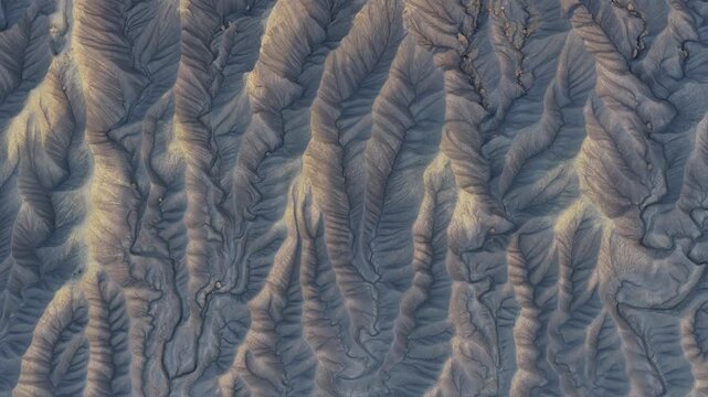 Aerial view of the eroded ridges and textured landscape of Factory Butte in Wayne County, Utah, United States.