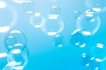 Clear Soap Bubbles on Blue Background. Freshness Soap Suds Bubbles Water. Celebration Festive Backdrop. Blue Gradient Blurred Background.  © Siwakorn1933