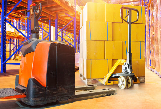Forklift Pallet Truck in Warehouse. Bulk of Package Boxes Shipment on Tall Shelves Storage Warehouse. Cartons, Cardboard Boxes. Supply Chain, Goods Shipment. Warehouse Shipping