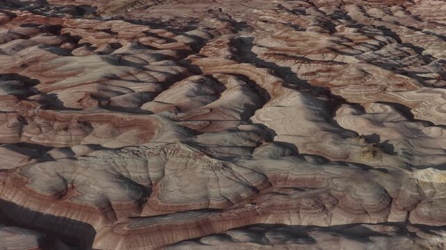 Aerial view of the colorful striped clay formations of the Bentonite Hills in Hanksville, Utah, United States.