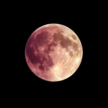 Full moon in deep red and orange hues during a total lunar eclipse in the night sky