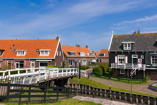 Marken village houses and bridge crossing canal in Netherlands