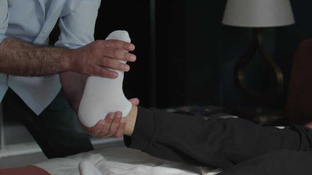 Physiotherapist Wrapping Bandage Around Patient Foot and Ankle Injury, Close Up of Hands Applying Medical Dressing During Home Treatment Footage, Physical Therapy and Healthcare Recovery Concept, Inju