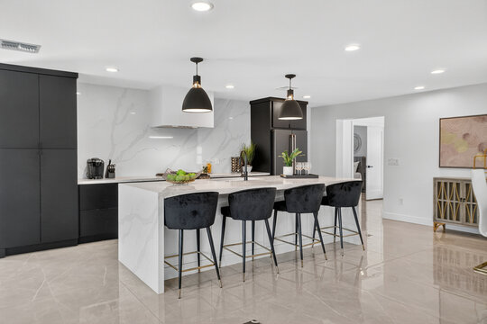 Bright kitchen with central island and bar stools