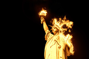  Statue of Liberty with burning fire isolated on black background © Maria