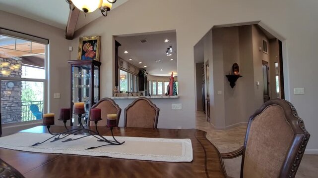 Sunlit dining room with open kitchen