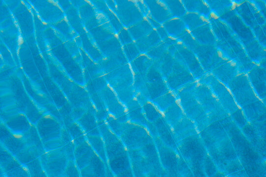 Clear blue water with light reflections on the background