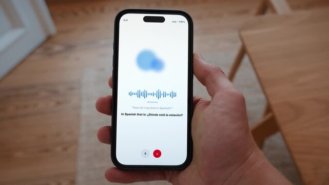 A voice assistant translates a spoken sentence live and shows both languages on screen. Point of view shot with the phone held in the hand. Useful for understanding each other.