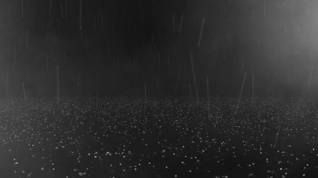 Heavy hail storm pellets falling and bouncing on floor surface in thick fog