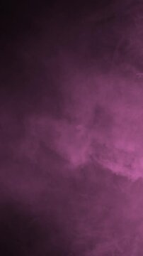 Dense soft pink smoke billowing slowly against black background, abstract vfx element in vertical video format