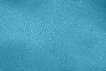 Obraz premium Detailed close up of vibrant teal blue synthetic leather textured material background with wrinkles