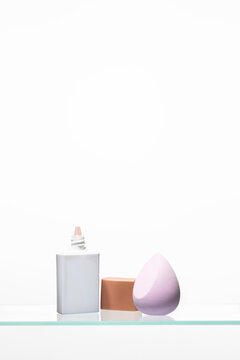 Essentials for a perfect daily beauty routine,cosmetic pump dispenser, face brush, and blending sponge, preparation and high-quality application.