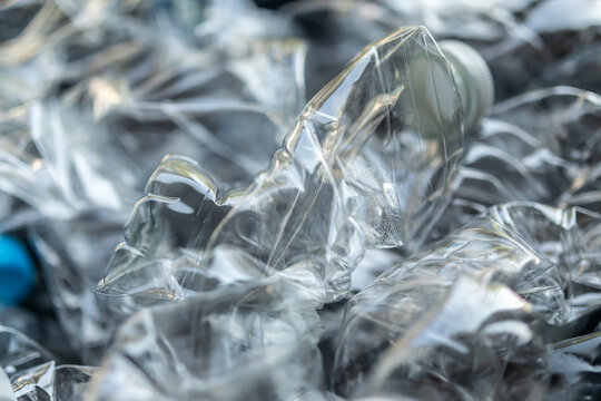 crushed plastic water bottles ready for recycling process, environmental pollution concept