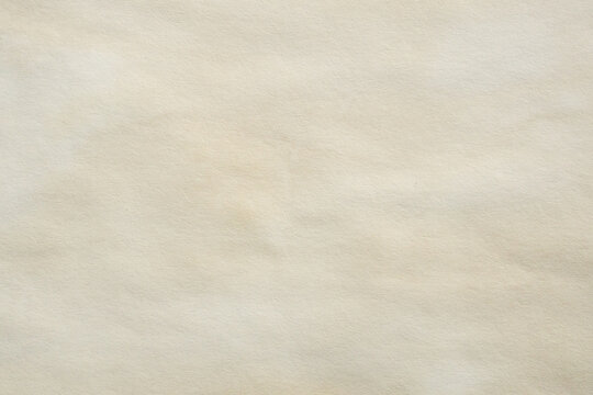 Old vintage paper texture background with aged stains and antique yellowed parchment effect
