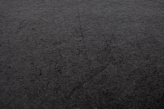 Black paper texture background with rough fiber surface and dark grey cardboard pattern