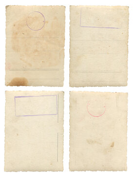 Set of four aged vintage postcard backs with faded postal markings, stamps and worn paper texture on white