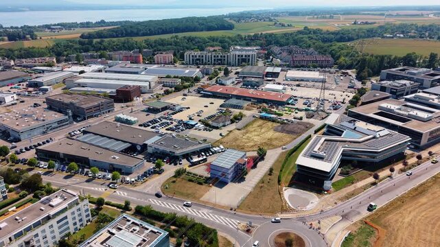Aerial view of modern office buildings and industrial facilities at Rte de Crassier 11 in Eysins, Vaud, Switzerland.