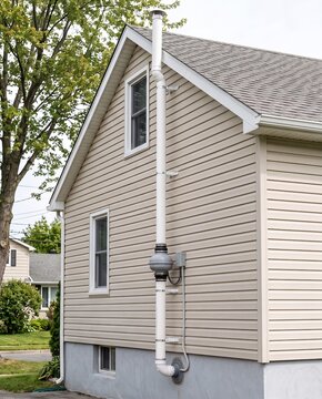 Exterior residential radon mitigation system installation