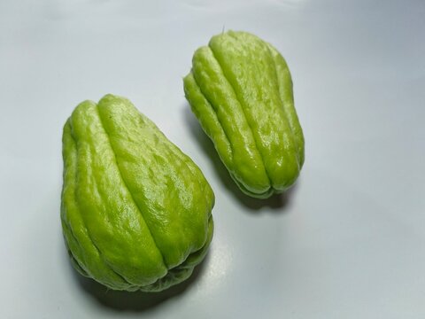 green chayote fruit on a white background