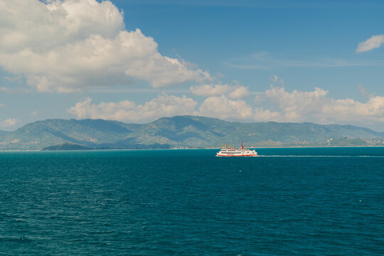 Passenger Ferry Crossing Before Mountainous Coastline