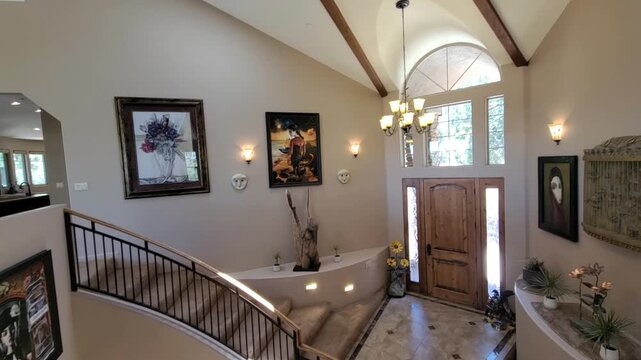 Elegant curved staircase foyer with natural light