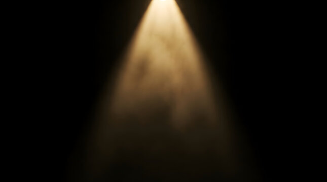 A bright golden spotlight beam shining down through a dark atmosphere creating a dramatic theatrical lighting effect on black background