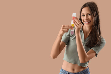 Beauty and self care, smiling young woman holding a stack of colorful nail polish bottles for...