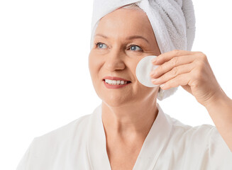 Healthy aging and skincare routine, senior woman applying facial toner with cotton pad for anti-aging treatment and wellness in a spa environment © Pixel-Shot