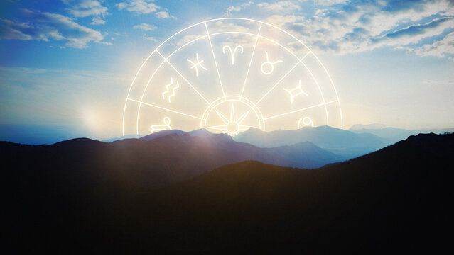 Astrology zodiac signs displayed against a mountain landscape at sunset