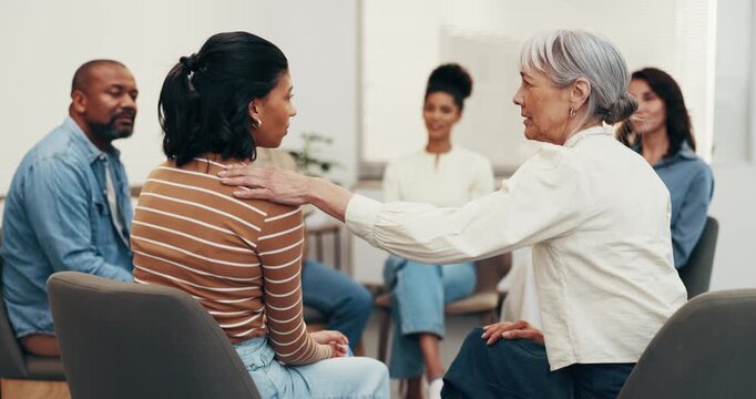 Therapy, group or women in center with support, understanding or empathy in clinic session. Mental health, patient or people with shoulder touch, encouragement or coping together in counseling.