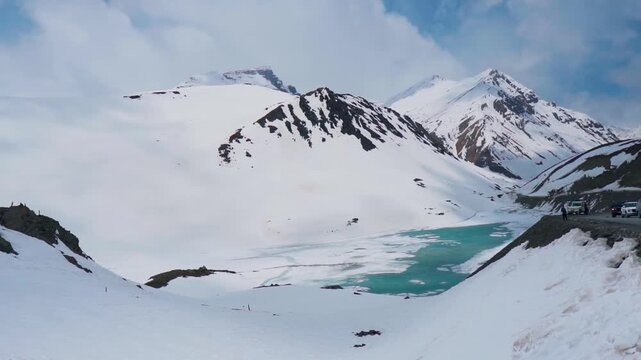 Wide angle shot of frozen Suraj Tal lake during the summer season as seen on the way towards Baralacha Pass Leh Manali highway in Lahaul and Spiti district, Himachal Pradesh, India. High Altitude lake