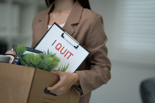 resignation, leave, quit, Stressful businesswomen will resign from the company. Female staff is lifting a brown paper box that holds personal items. , job placement and vacancies, resignation letter
