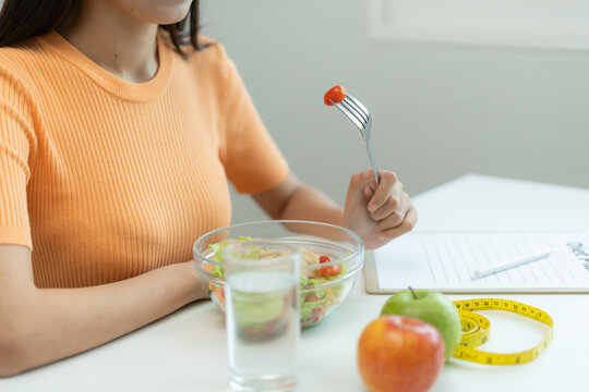 Beauty slim female body choose healthy foods. Woman take note diet progress, healthy life, low calorie, thin waist, nutritionist. Dieting, body shape, balance control, avoid, nutritional
